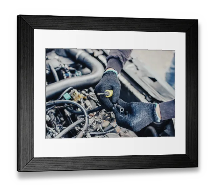 Framed Print : Hands repairing an engine with a tool