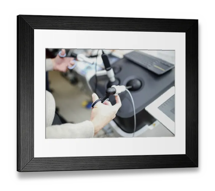 Framed Print : Hands interacting with a medical device operating controls