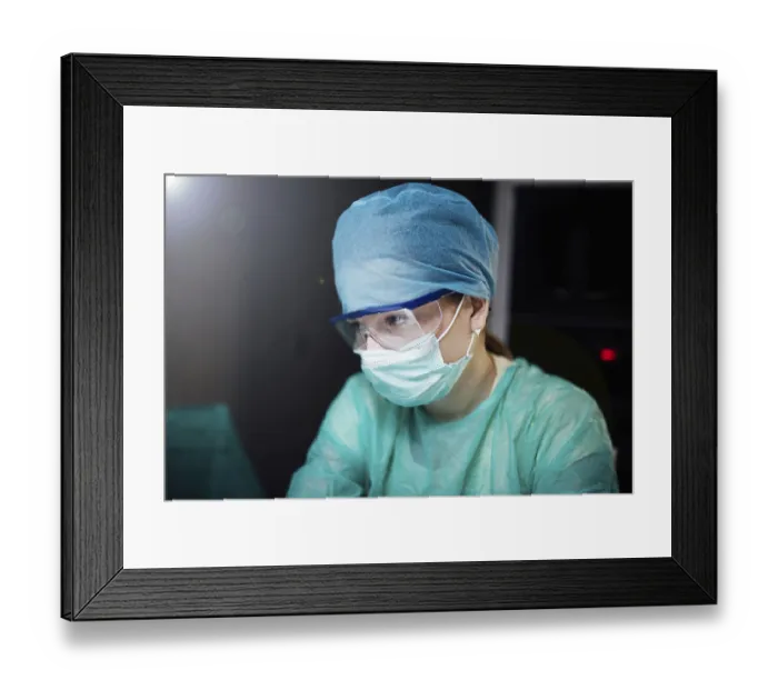 Framed Print : A healthcare worker in protective gear focused on a task Framed Print : A healthcare worker in protective gear focused on a task
