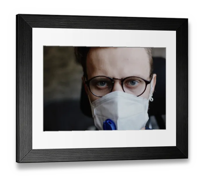 Framed Print : Close-up of a man wearing a medical mask and glasses