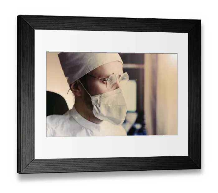 Framed Print : Doctor in mask and glasses, basked in warm sunlight