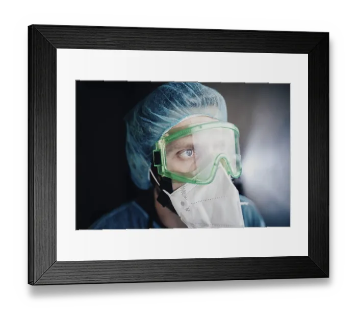 Framed Print : Close-up of a medical professional wearing green goggles and a mask