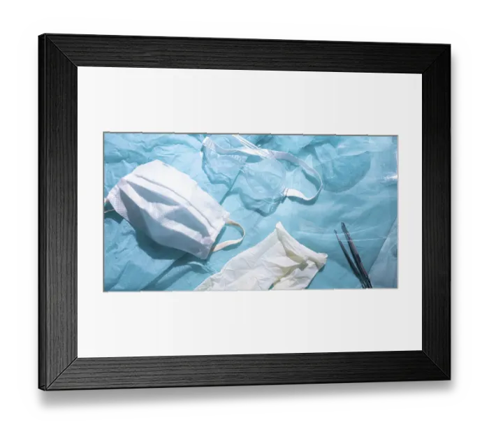 Framed Print : Medical mask and gloves next to goggles on a blue fabric background