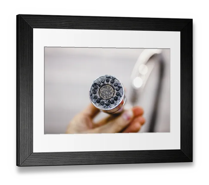 Framed Print : Close-up of a shower head held in a hand Framed Print : Close-up of a shower head held in a hand