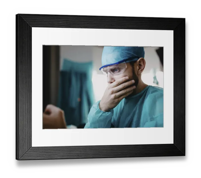 Framed Print : A surgeon in blue attire, appearing concerned with a hand on the mouth Framed Print : A surgeon in blue attire, appearing concerned with a hand on the mouth
