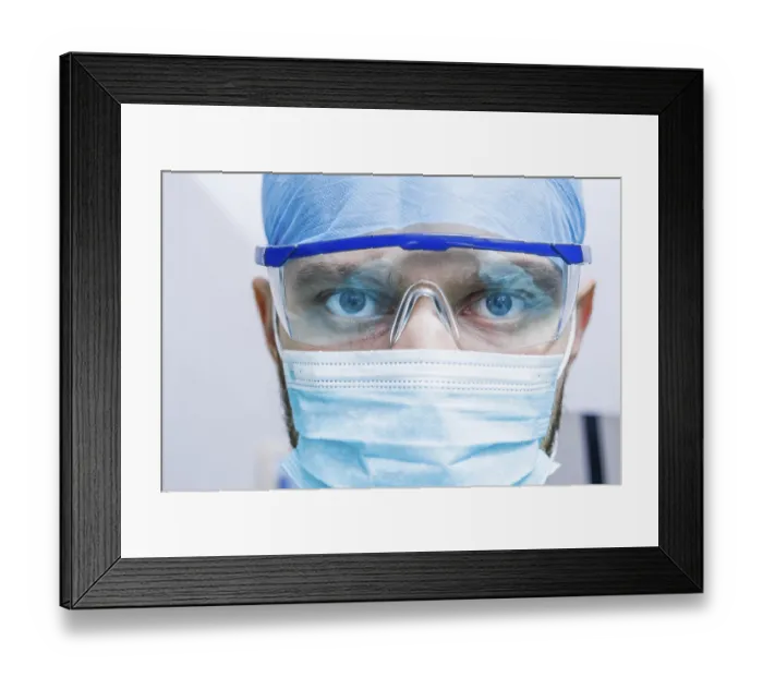 Framed Print : Close-up of a surgeon with intense eyes behind glasses Framed Print : Close-up of a surgeon with intense eyes behind glasses