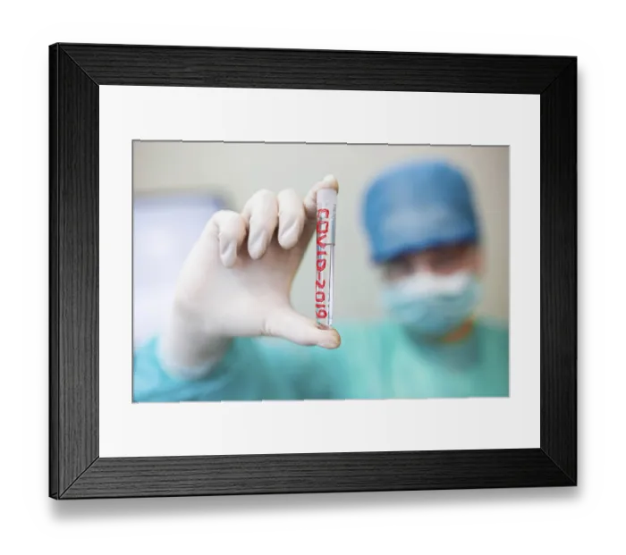 Framed Print : Hand holds a test tube labeled COVID-2019 against a blurred medical background Framed Print : Hand holds a test tube labeled COVID-2019 against a blurred medical background