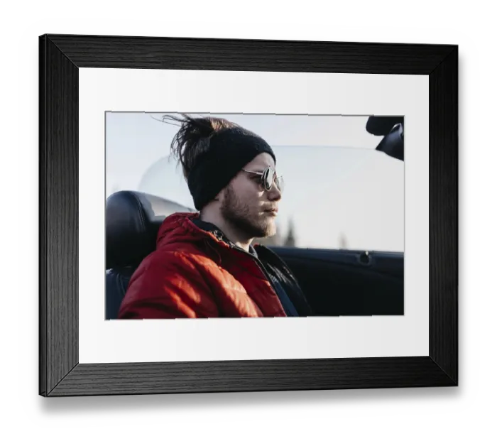 Framed Print : Man in sunglasses and red jacket sits in a convertible