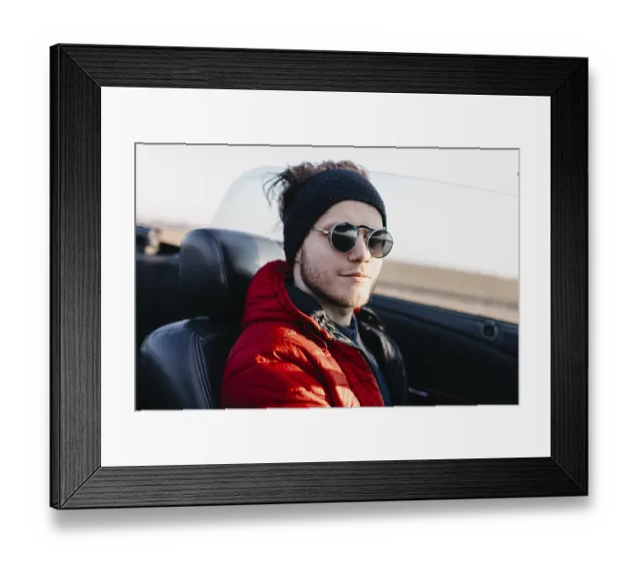 Framed Print : Man wearing sunglasses and a red jacket in a convertible