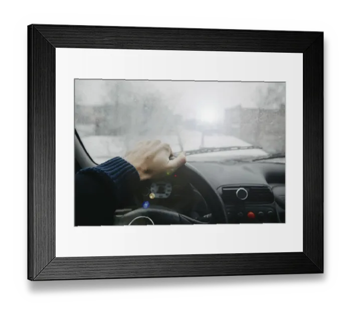 Framed Print : Driver view with hand on steering wheel in foggy conditions