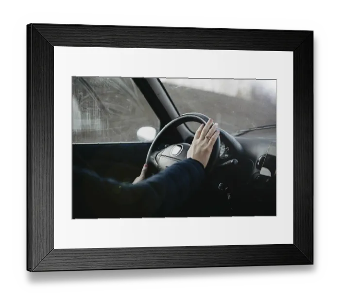 Framed Print : Hand resting on a steering wheel as if about to press the horn