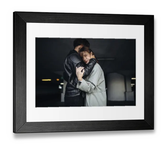 Framed Print : A couple in a comforting embrace in a subdued setting Framed Print : A couple in a comforting embrace in a subdued setting