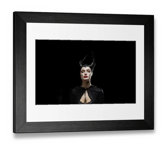 Framed Print : A portrait of a woman in a dark costume with horns and dramatic expression