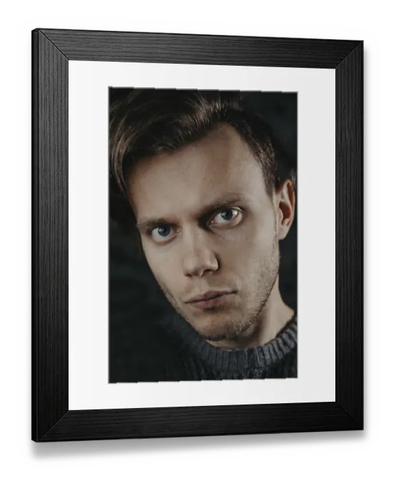 Framed Print : Portrait close-up of a man with captivating eyes against a dark backdrop