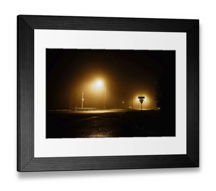 Framed Print : Foggy night street with glowing streetlights casting yellow light on a dark and quiet road Framed Print : Foggy night street with glowing streetlights casting yellow light on a dark and quiet road
