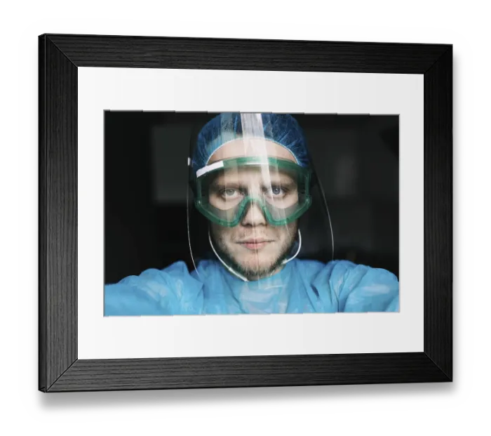Framed Print : A medical professional wearing protective gear including a face shield and goggles Framed Print : A medical professional wearing protective gear including a face shield and goggles