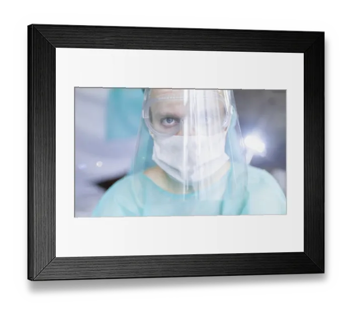 Framed Print : Person wearing a medical mask and face shield