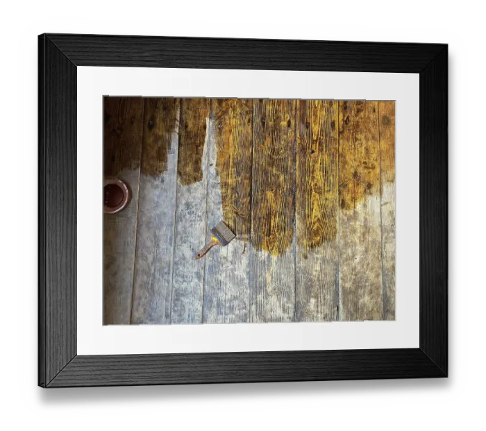 Framed Print : Brush placed on wooden floor in the process of being stained showing texture details