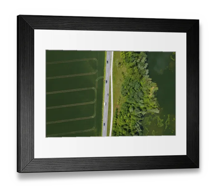 Framed Print : Drone image, country road between fields and pond Framed Print : Drone image, country road between fields and pond