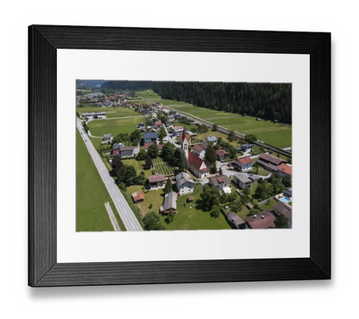 Framed Print : Drone shot, view of village with parish church Framed Print : Drone shot, view of village with parish church