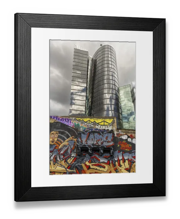 Framed Print : A modern high-rise building with a reflective glass facade Framed Print : A modern high-rise building with a reflective glass facade