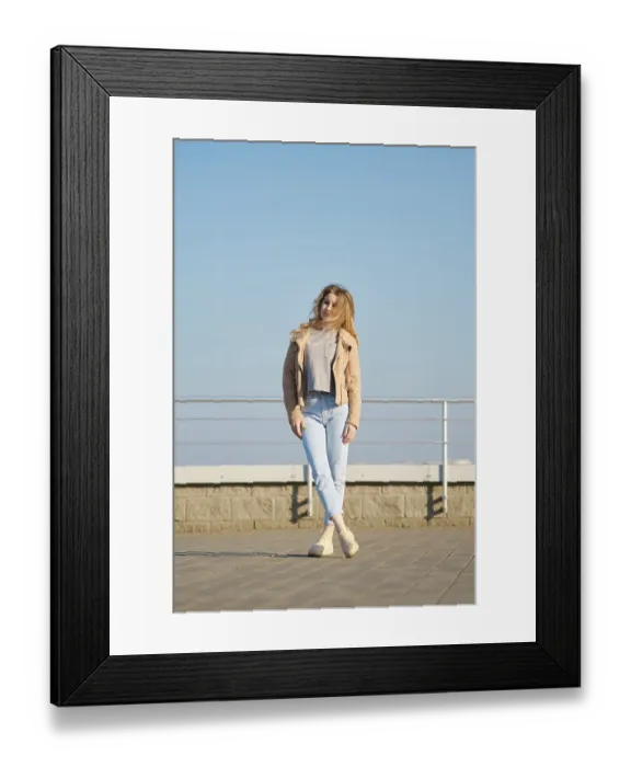 Framed Print : A young woman stands on a modern rooftop terrace