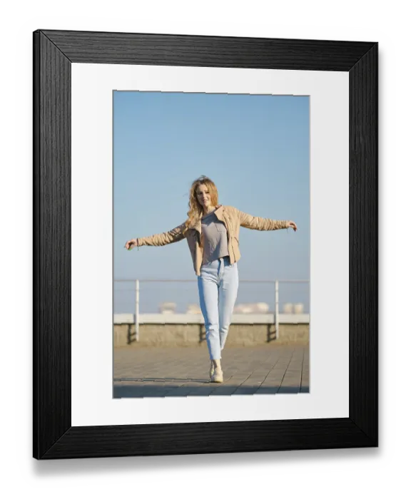 Framed Print : A young woman with long, flowing hair strides across a rooftop terrace on a clear