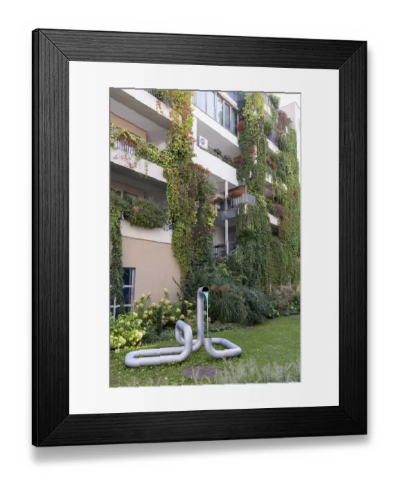 Framed Print : Modern facade with lush greenery and a sculpture in the front garden