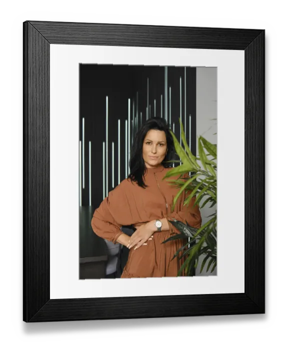Framed Print : Casual lifestyle portrait of charming woman with black hair wearing brown dress posing near the potted plant