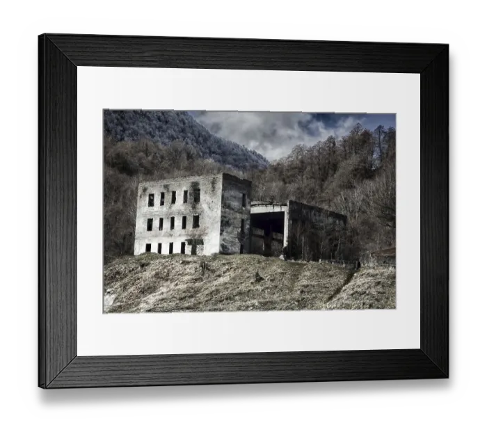 Framed Print : The ruins of a three-storey house with a hangar on the background of winter forest mountains Framed Print : The ruins of a three-storey house with a hangar on the background of winter forest mountains