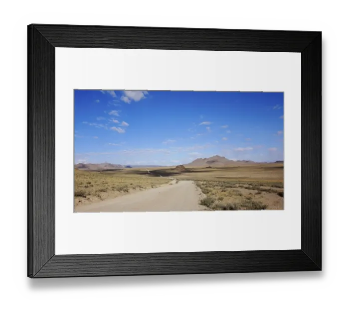 Framed Print : Landscape of outdoor road in wild field with mountains at horizon