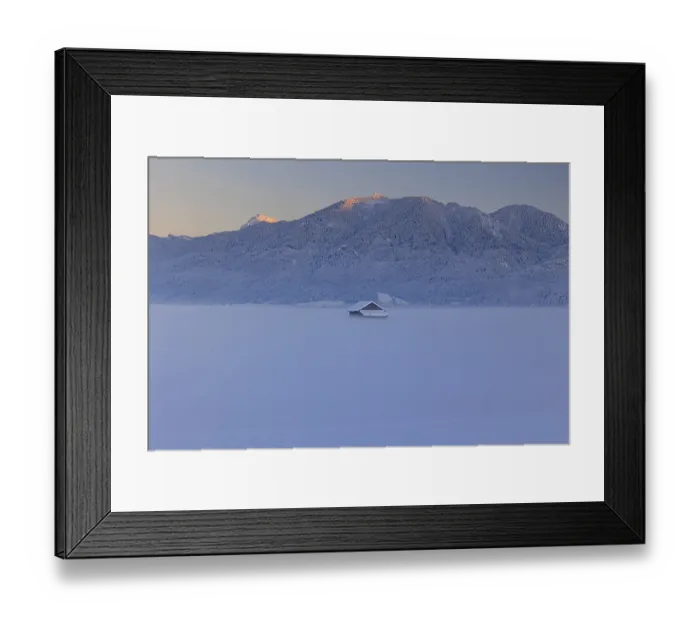 Framed Print : Hut in the snow in front of mountains