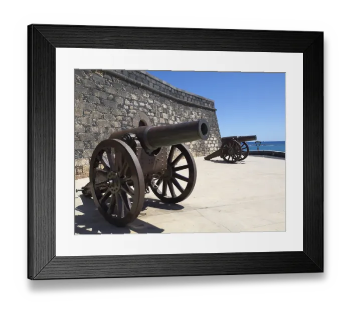 Framed Print : Two ancient cannons next to a fortress with a view of the sea Framed Print : Two ancient cannons next to a fortress with a view of the sea