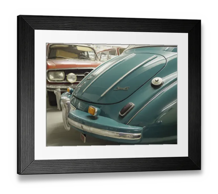 Framed Print : Rear view of a blue vintage car with chrome-plated bumper under a hall ceiling