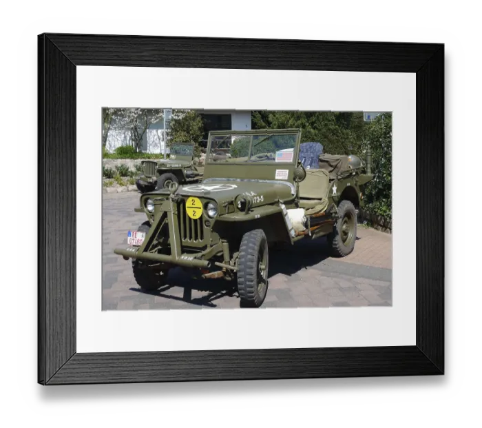Framed Print : Green vintage jeep with military markings parked on a paved area Framed Print : Green vintage jeep with military markings parked on a paved area
