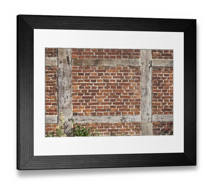 Framed Print : Brick wall and wooden beams on a half-timbered house in the historic centre of Harburg Framed Print : Brick wall and wooden beams on a half-timbered house in the historic centre of Harburg