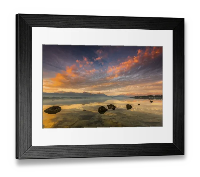 Framed Print : Forggensee with reflection of the cloudy sky and the Allgauer mountains in the background at sunrise Framed Print : Forggensee with reflection of the cloudy sky and the Allgauer mountains in the background at sunrise