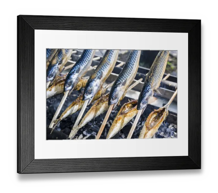 Framed Print : Stockfisch, fish dish prepared on wooden stick being barbecued