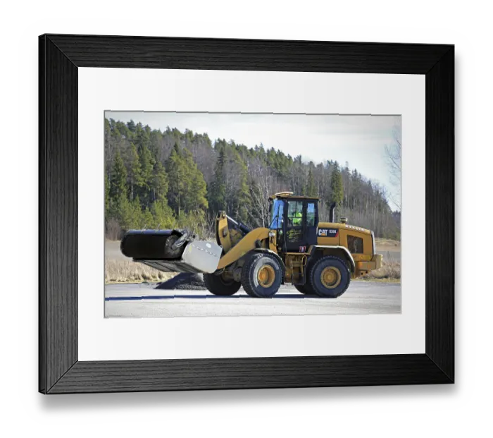 Framed Print : PAIMIO, FINLAND, MARCH 18, 2017: CAT 938K wheel loader and bucket sweeper at work to clean an asphalt yard at spring