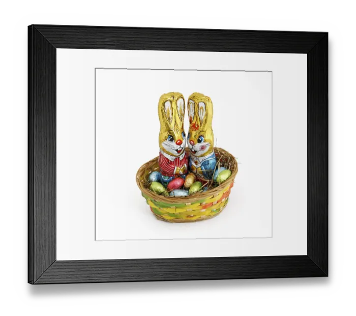 Framed Print : Two Easter bunnies in a basket with chocolate eggs