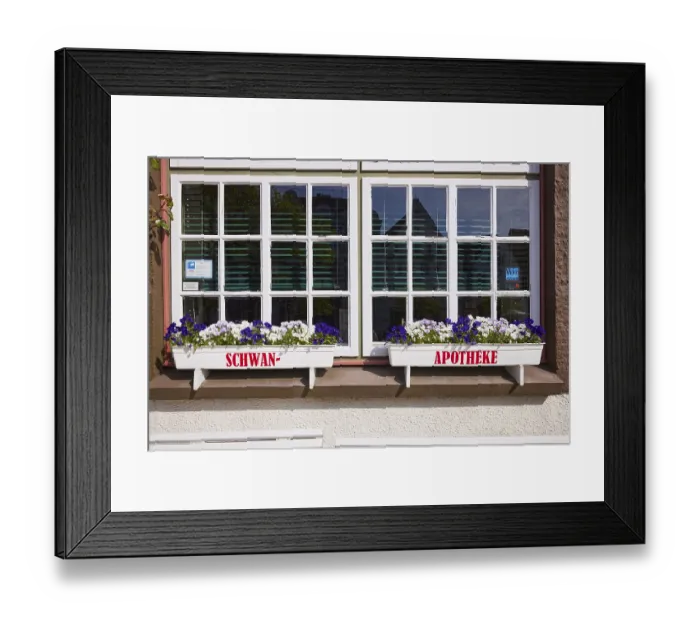 Framed Print : Window with flower boxes of the Swan pharmacy in the city centre of Husum