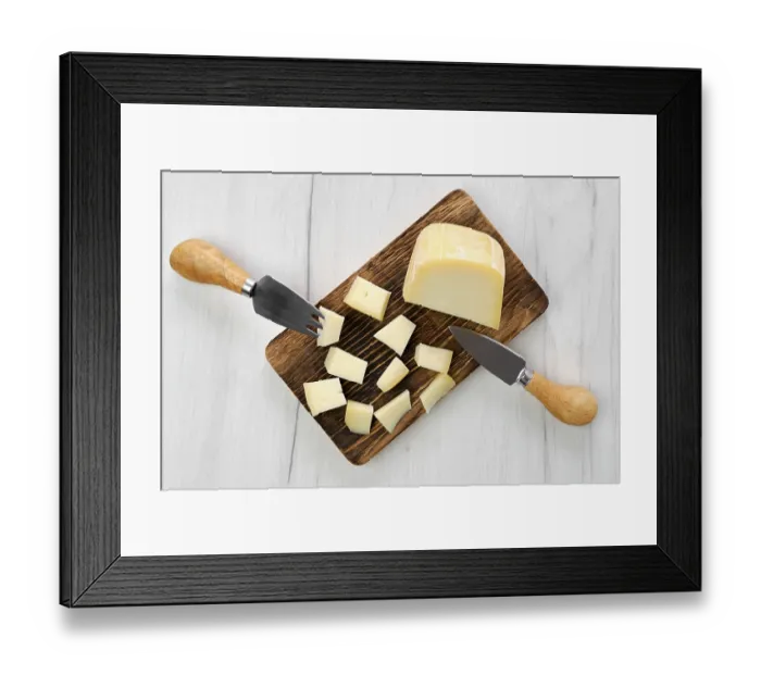 Framed Print : Top view of goat cheese cut on pieces on wooden cutting board Framed Print : Top view of goat cheese cut on pieces on wooden cutting board
