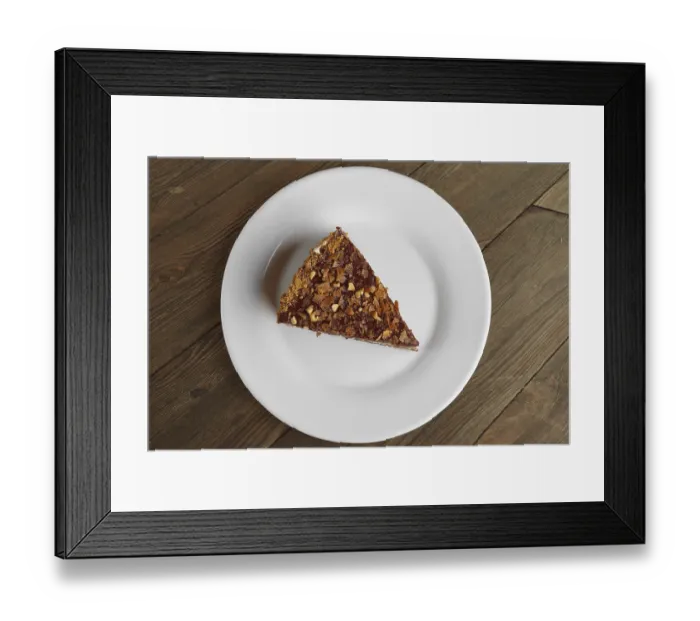 Framed Print : Top view of chocolate sliced cake on wooden table