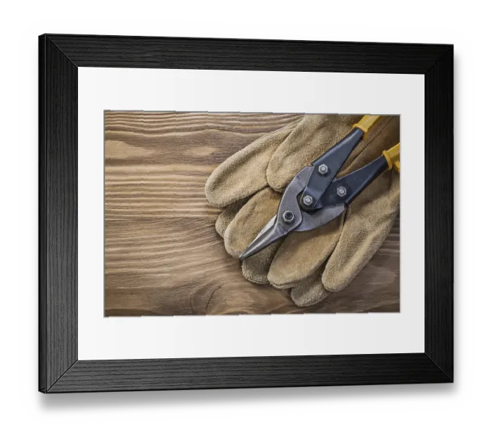 Framed Print : Pair of protective gloves steel cutter on vintage wooden board construction concept