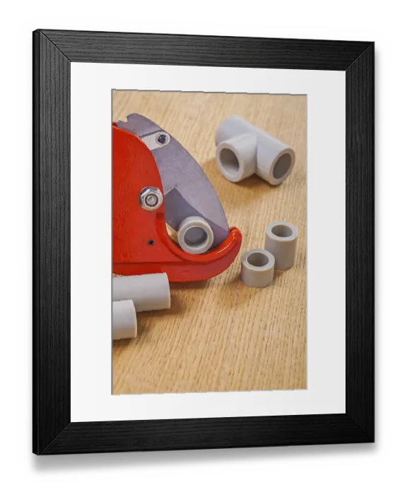 Framed Print : Pipe cutter and polypropylene cutted pipes on wooden boards