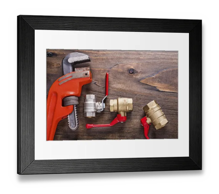 Framed Print : Plumbers fixtures with red handles and monkey wrench on vintage wooden board construction concept