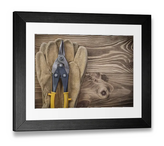 Framed Print : Protective gloves metal tin snips on wooden board construction concept