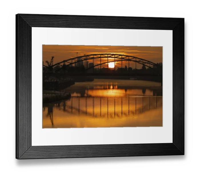 Framed Print : The sun rises behind the Deutschherrn Bridge Framed Print : The sun rises behind the Deutschherrn Bridge