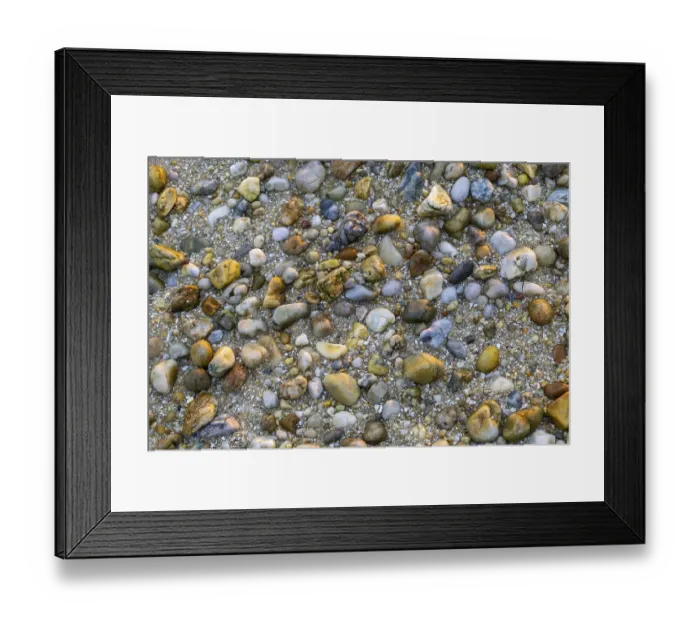 Framed Print : A close up abstract background view of rocks and pebbles on a golden sand beach Framed Print : A close up abstract background view of rocks and pebbles on a golden sand beach