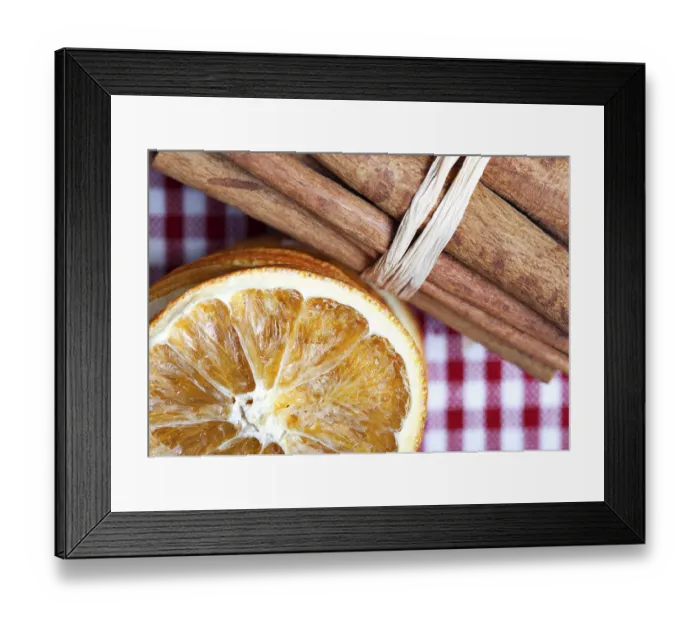 Framed Print : Slices of dried orange and cinnamon sticks on a chequered cloth Framed Print : Slices of dried orange and cinnamon sticks on a chequered cloth